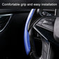 Blue carbon-fiber textured steering wheel cover grip, steering controls visible.