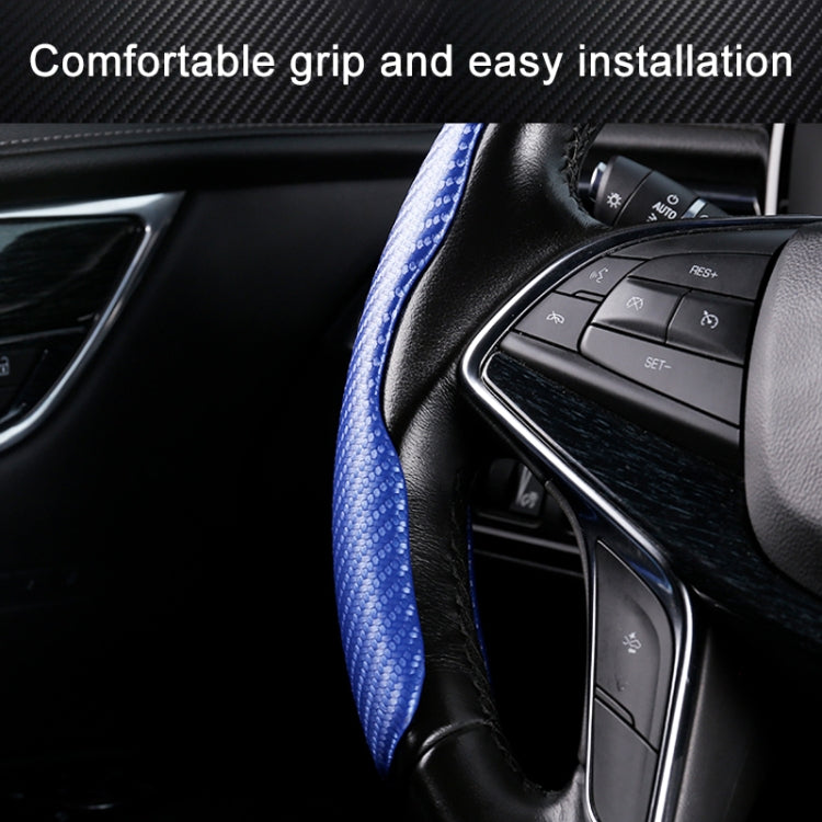 Blue carbon-fiber textured steering wheel cover grip, steering controls visible.