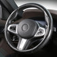 Black steering wheel cover with carbon fiber side panels and stitched edge
