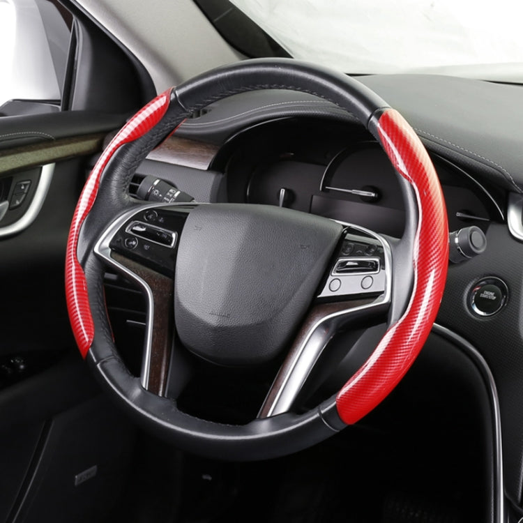 Red carbon fiber steering wheel cover with black stitched grip on car wheel