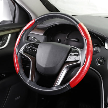 Red carbon fiber steering wheel cover with black stitched grip on car wheel
