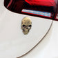 Bronze devil skull car sticker with cracked pattern and black sunglasses, mounted on car