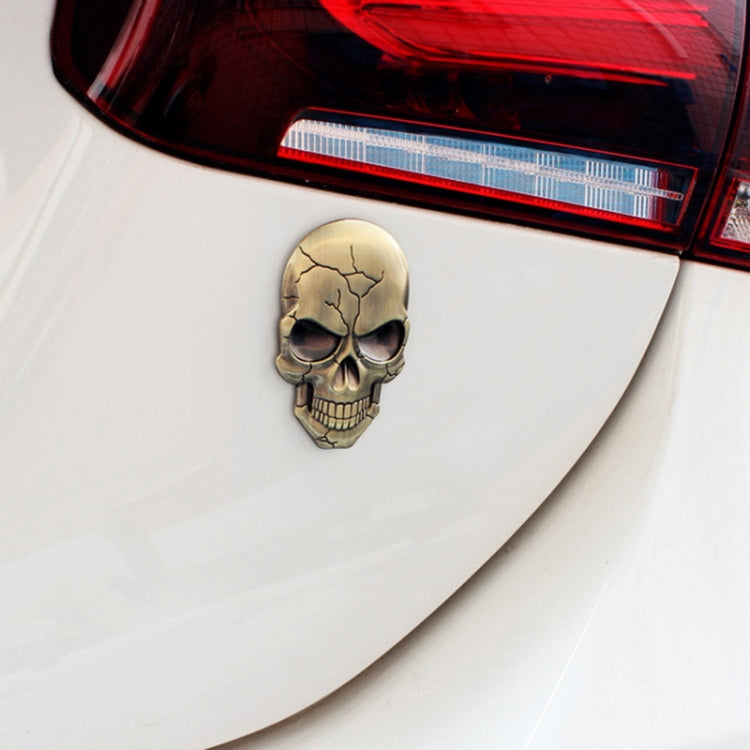 Bronze devil skull car sticker with cracked pattern and black sunglasses, mounted on car
