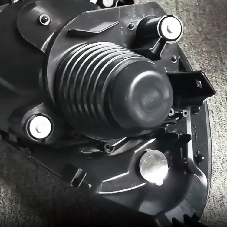 Headlamp with black dust cover fitted over bulb opening, ribbed rubber boot