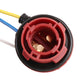 Red brake light socket holder close-up with brass contacts and wire lead ports