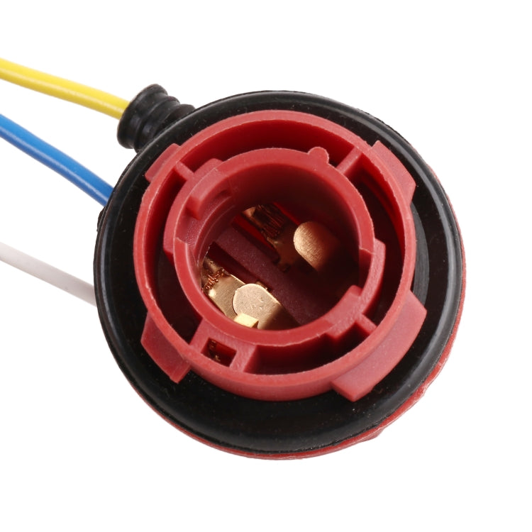 Red brake light socket holder close-up with brass contacts and wire lead ports