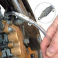 Motorcycle hydraulic brake bleeder adapter with clear tube connected to brake fitting