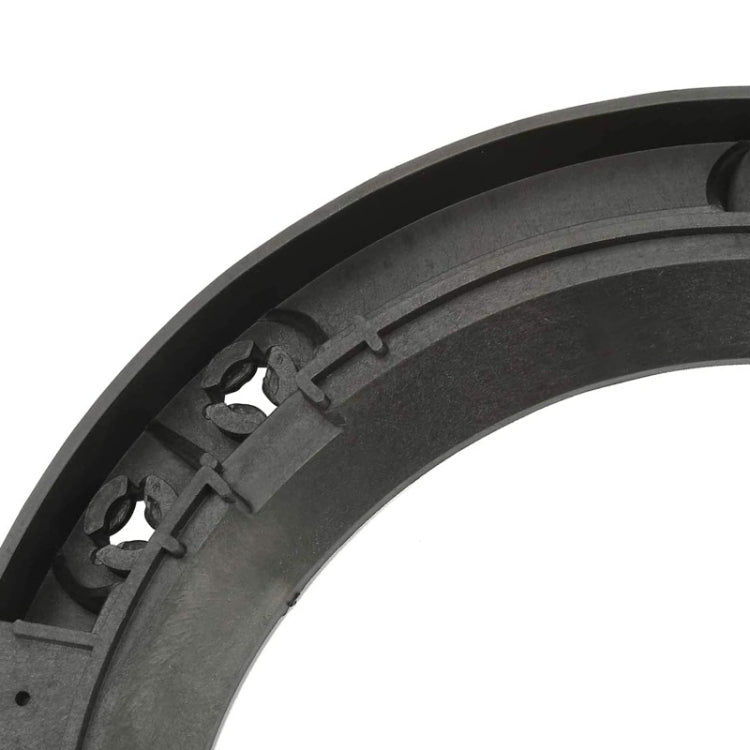 Close-up of black plastic headlight inside bracket with mounting clip details