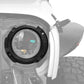 Installed black plastic headlight inside bracket ring on front headlamp housing