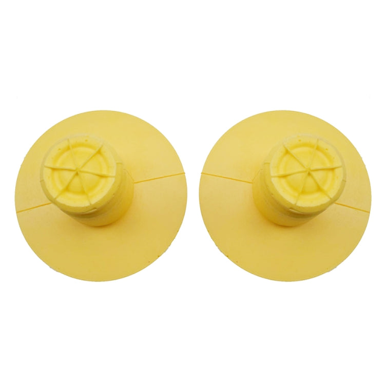 Two yellow bump stop absorbers with domed cap and circular base