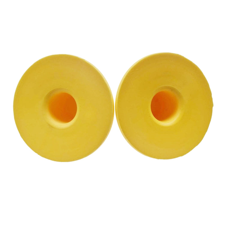 Pair of yellow bump stop absorbers with orange center holes on circular bases