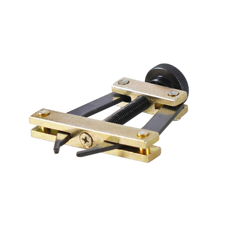 Side view of roller chain tensioner tool with gold base, threaded screw, and roller wheel