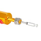Close-up of gold hydraulic master cylinder rod with silver lock nut and clevis pin