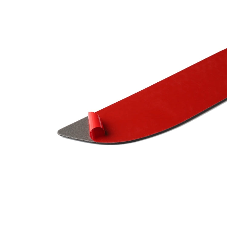 Carbon fiber-look handle sticker with red backing clip for attachment.