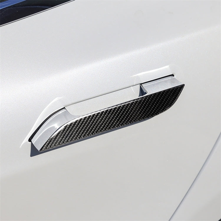 Carbon fiber-look outside door handle sticker applied on white car door.
