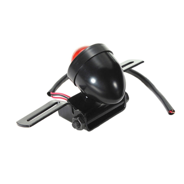 Single black motorcycle round brake light with red lens, bracket mount, and wires