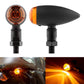 Motorcycle retro turn signal light pair with black housing and amber/orange lens