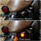 Installed motorcycle turn signal light with amber lens on black bracket
