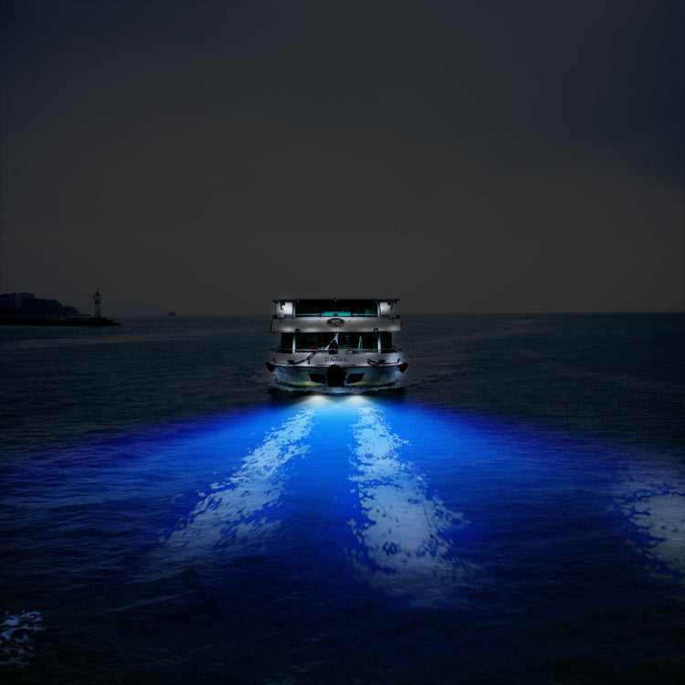 Underwater LED light mounted on a boat, casting a blue beam on the water