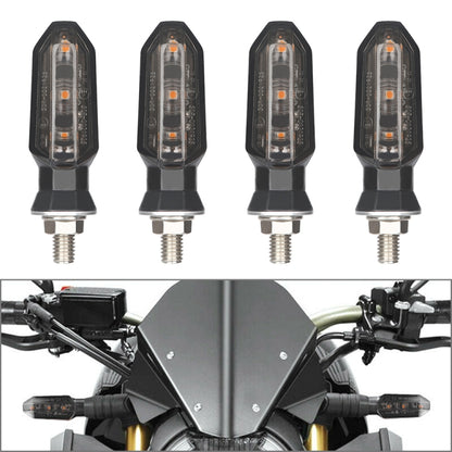 Black motorcycle LED turn signal light, clear lens with amber glow