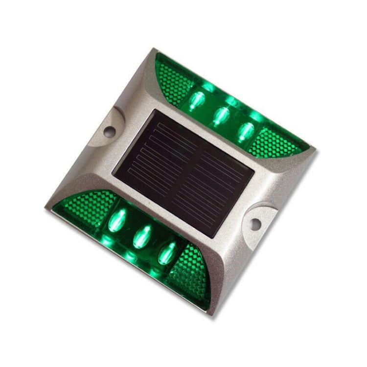 Silver solar LED road stud light with green flashing bulbs in top and bottom bars
