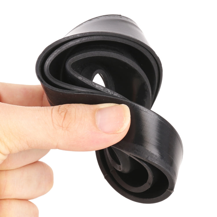 Hand holding a universal headlight dust cover, black silicone with circular opening