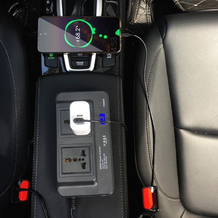 Car setup with power inverter plugged into vehicle outlet, showing blue voltage LED