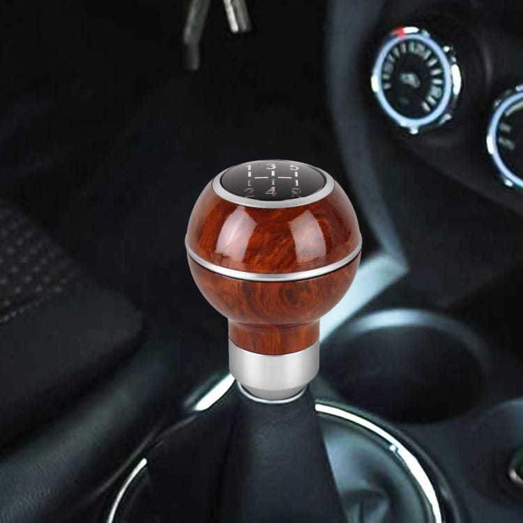 Wood-texture gear shift knob with blue base ring and black numbered shift panel