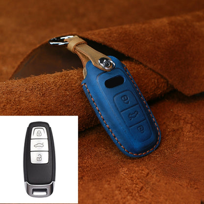 Blue leather key fob cover with metal ring and stitched edges, key button cutout