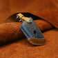 Blue leather key protective cover case with metal keyring, stitched edges, and key button cutout