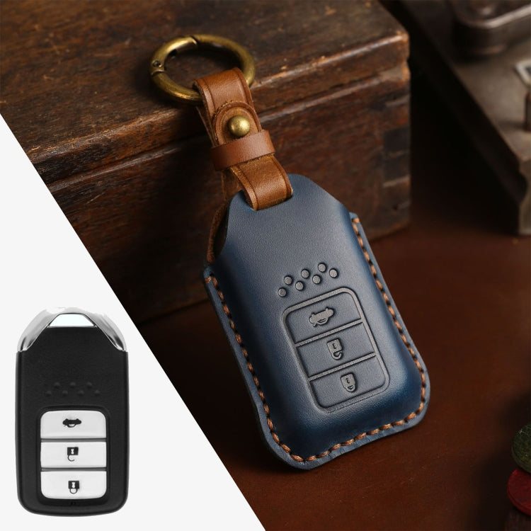 Blue cowhide leather key fob cover with metal ring loop and embossed control buttons.