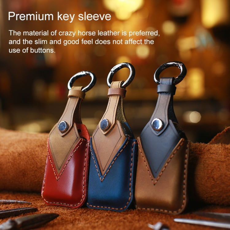 Set of three leather key fob covers: red, blue, and tan with key ring loops.