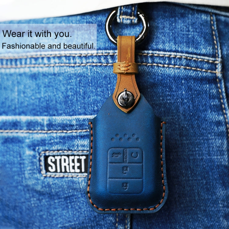 Blue leather key fob cover with key ring loop, embossed button panel, and orange stitching.