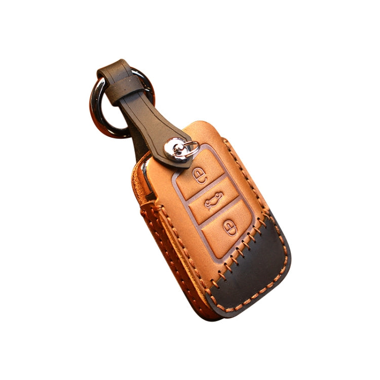 Tan and dark leather key cover case with metal ring, stitched trim, and key buttons panel