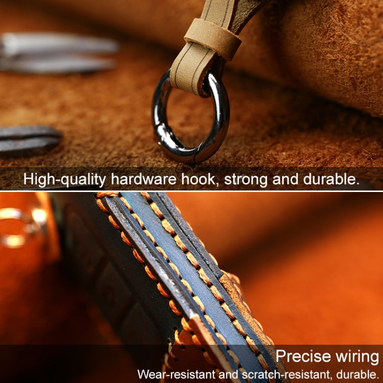 Leather key cover close-up with metal ring and blue-stitched side edge panel