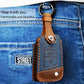 Brown leather key cover with metal ring, stitched trim, and key button cutouts