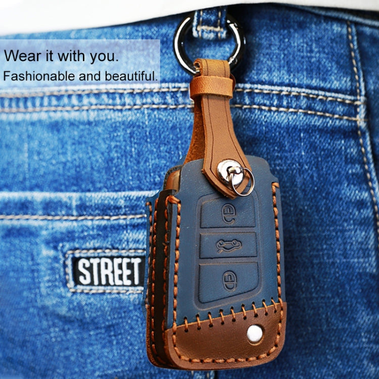 Brown leather key cover with metal ring, stitched trim, and key button cutouts