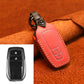 Leather key protective cover in red with two-button panel, keyring loop.