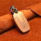 Leather key protective cover with two-button fob insert, tan/brown, stitched edges.