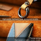 Leather key cover with metal keyring and button panel, tan/brown.