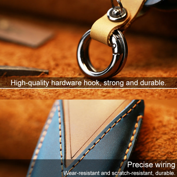 Leather key cover with metal keyring and button panel, tan/brown.