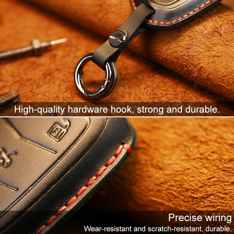 Black leather key fob cover with red stitched edge and metal key ring