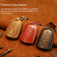 Leather key fob covers in tan, brown, black, and red with key ring loops