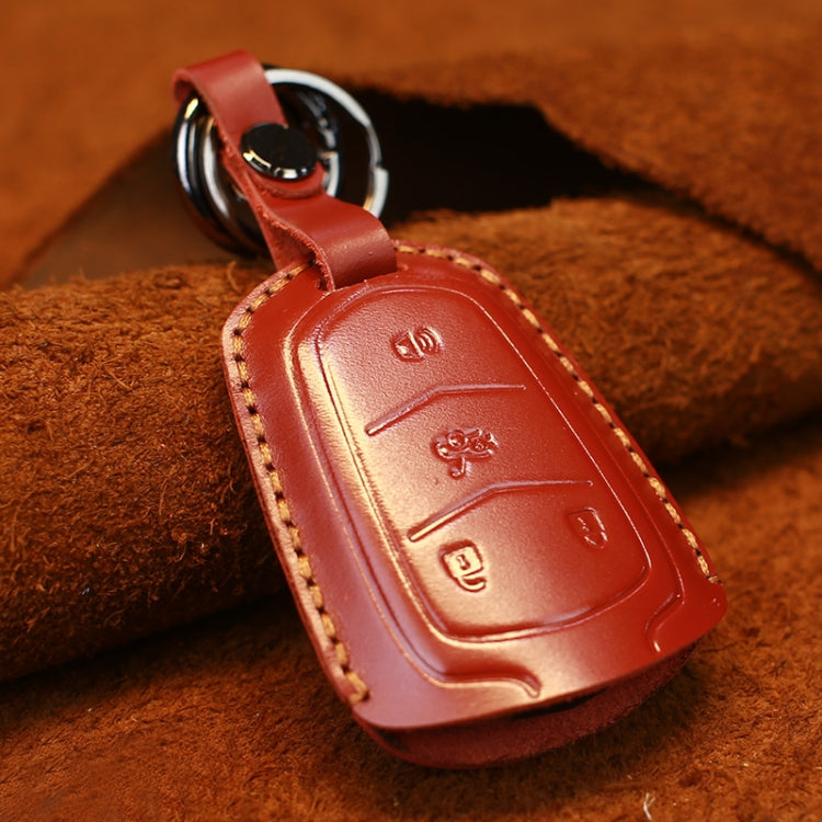 Red leather key fob cover with embossed buttons, red-stitched edge and key ring
