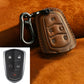 Brown leather key fob cover with red stitching and metal carabiner clip