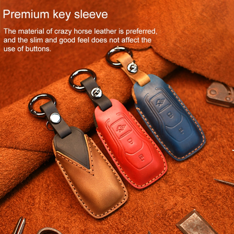 Leather key fob covers with keyrings in blue, red, and brown, stitched edges