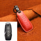Red leather key fob cover with keyring and stitched edges, protective sleeve
