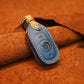 Blue leather key fob protective cover with tan stitched edges and metal key ring