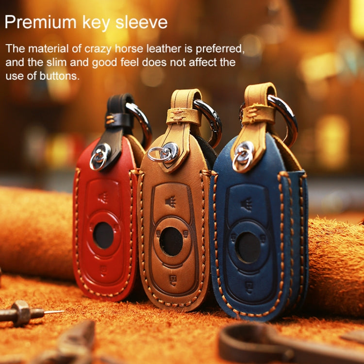 Set of three leather key fob covers: red, brown, and blue with metal key rings