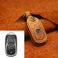 Tan leather key fob protective cover with tan strap, stitching, and metal key ring
